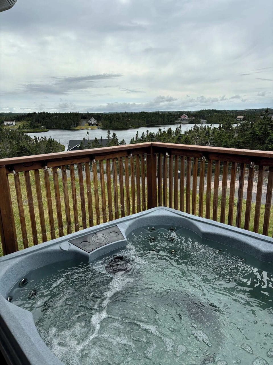 Private outdoor hot tub with relaxing pond and nature views.