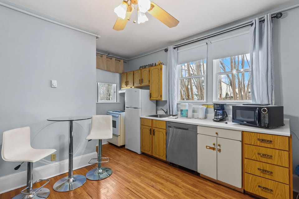 Fully equipped kitchen with refrigerator, stove, microwave, coffee maker, and ample cabinet space.