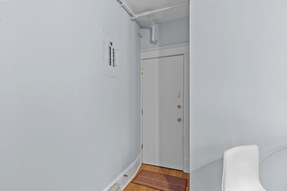 Private entryway with secure door access and bright, clean interior hallway.