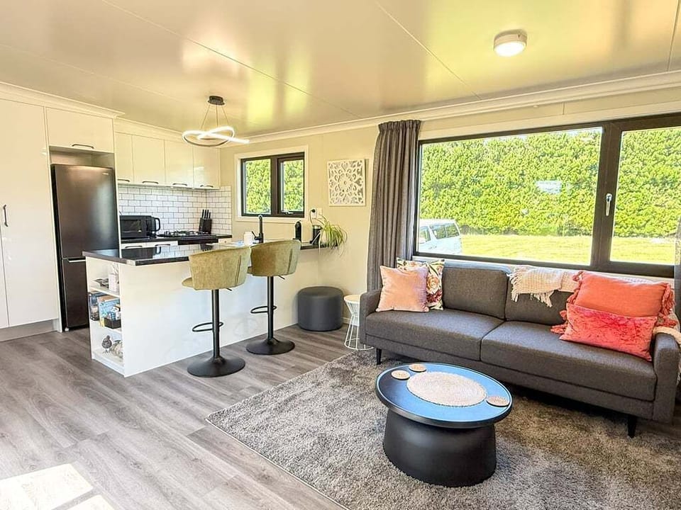 Light-filled open-plan living with comfortable seating and wide rural views