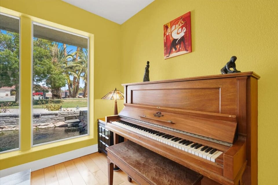 Rarely found in a vacation home, this dedicated music room features a piano, electric keyboard, electric guitar, and additional instruments, creating a vibrant space for connection, creativity, and pure fun.