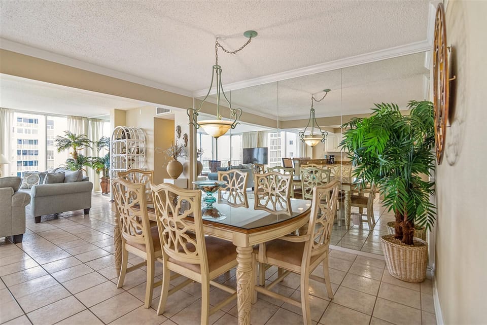 Gather around this spacious dining table where your group can share meals with stunning city views streaming through floor-to-ceiling windows.