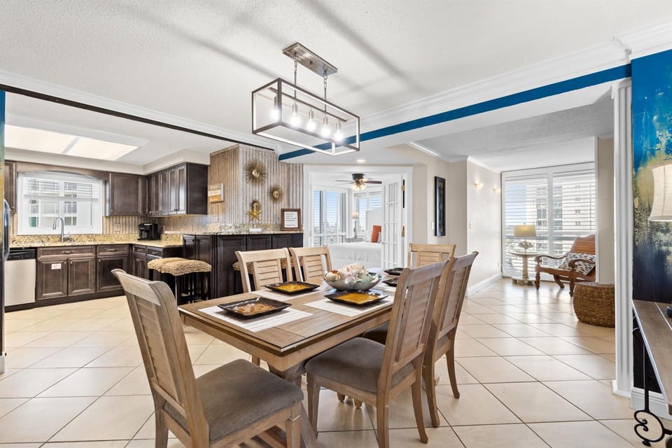 Gather around your stylish dining table in this open-concept space, where the modern kitchen beckons for morning coffee and memorable meals together.