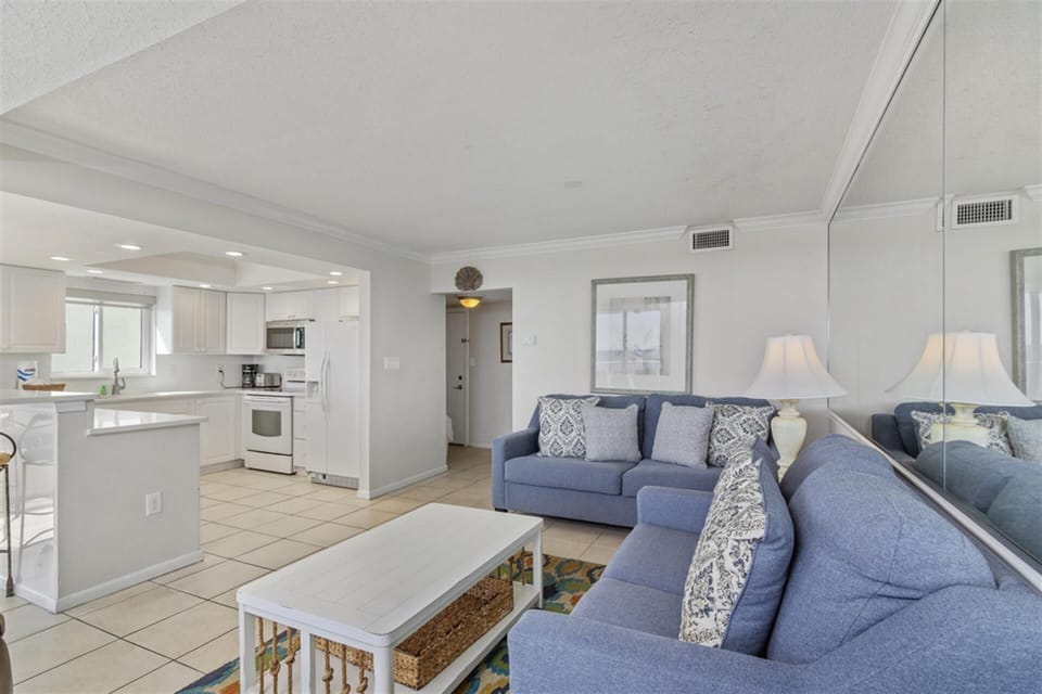 Unwind in your bright, open living space where coastal blues meet crisp whites, creating the perfect backdrop for memorable vacation moments.