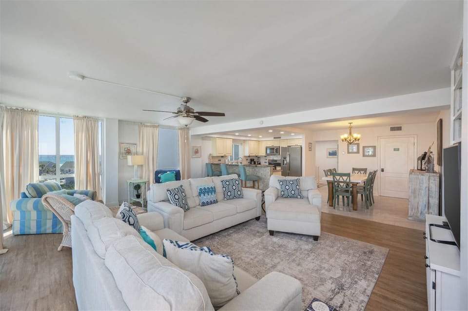 Relax in this bright, coastal-inspired living space where soft blues meet comfortable seating and stunning views.
