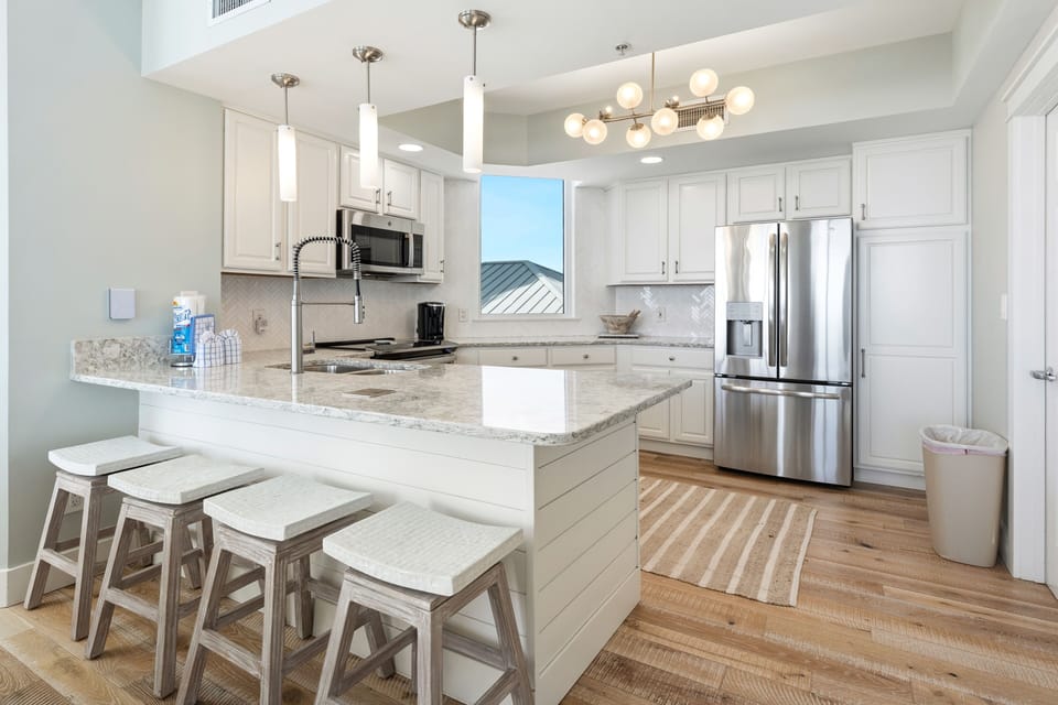 Your modern kitchen invites culinary creativity with granite counters, stainless appliances, and a bright breakfast bar perfect for morning coffee.