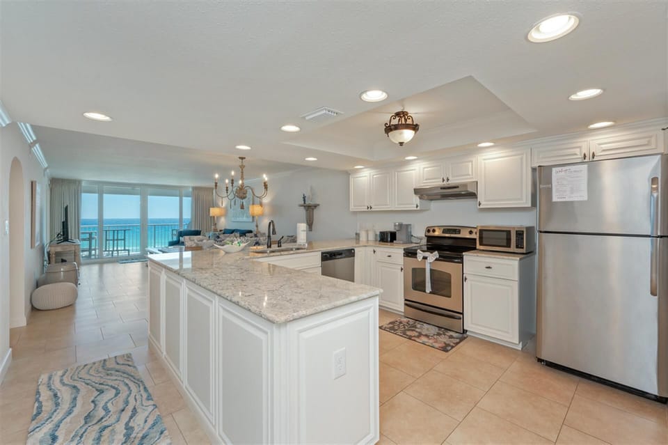 Your fully equipped kitchen features granite counters, stainless appliances, and opens to breathtaking ocean views.