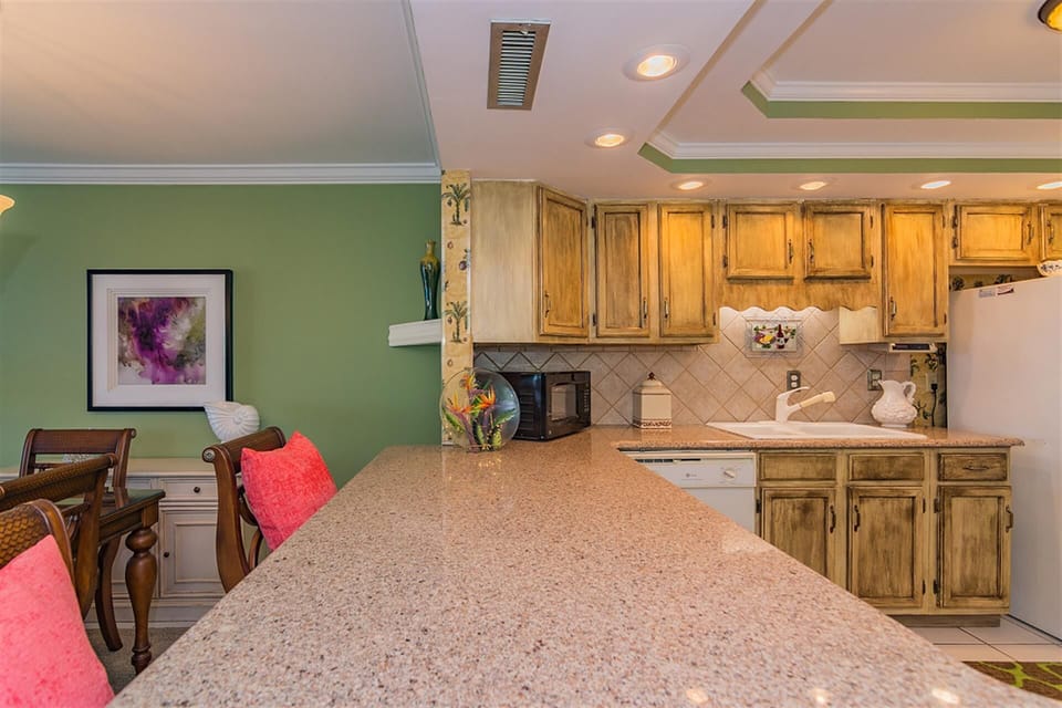 Your fully-equipped kitchen features granite counters, warm wood cabinets, and everything needed to create memorable meals during your stay.