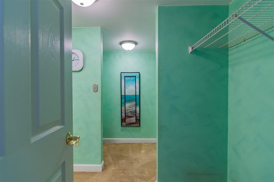 Your private laundry space features calming turquoise walls and convenient storage to keep your vacation wardrobe fresh.