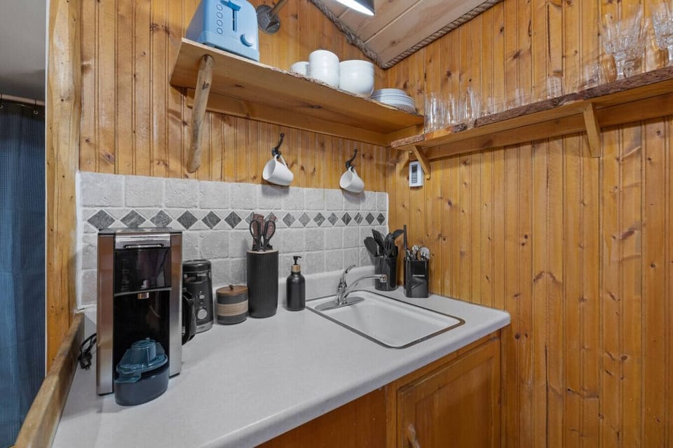 Start your day at the coffee station, stocked with mugs, glassware, and everything you need for a perfect brew.