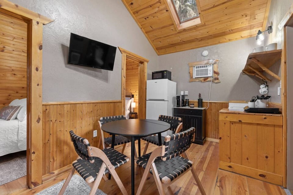 Dining nook, TV, and compact kitchenette in one cozy space.