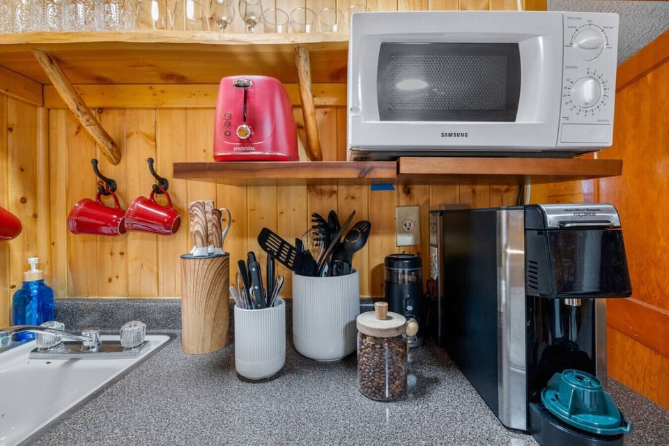 Cozy cabin kitchenette with everything for quick bites and fresh coffee.