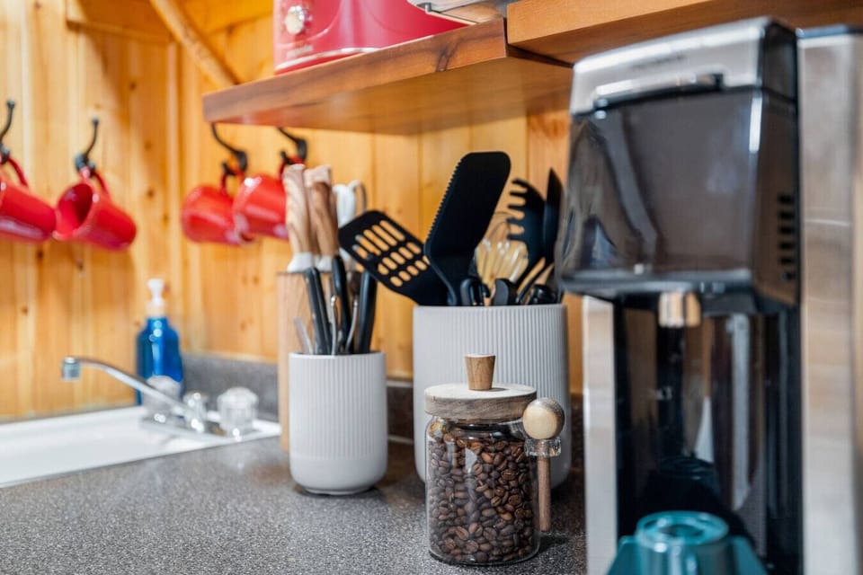 Cabin coffee bar with beans, mugs, and cookware essentials for a comfortable Black Hills cabin stay.