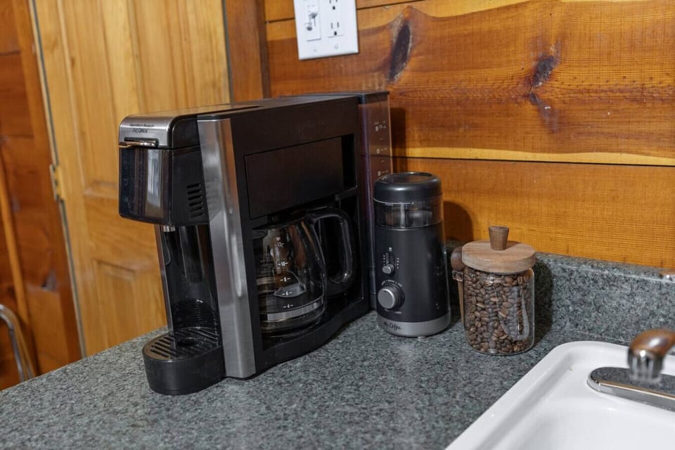 Enjoy morning rituals at your own coffee station, complete with all the essentials—mugs, glassware, and a handy sink for convenience.