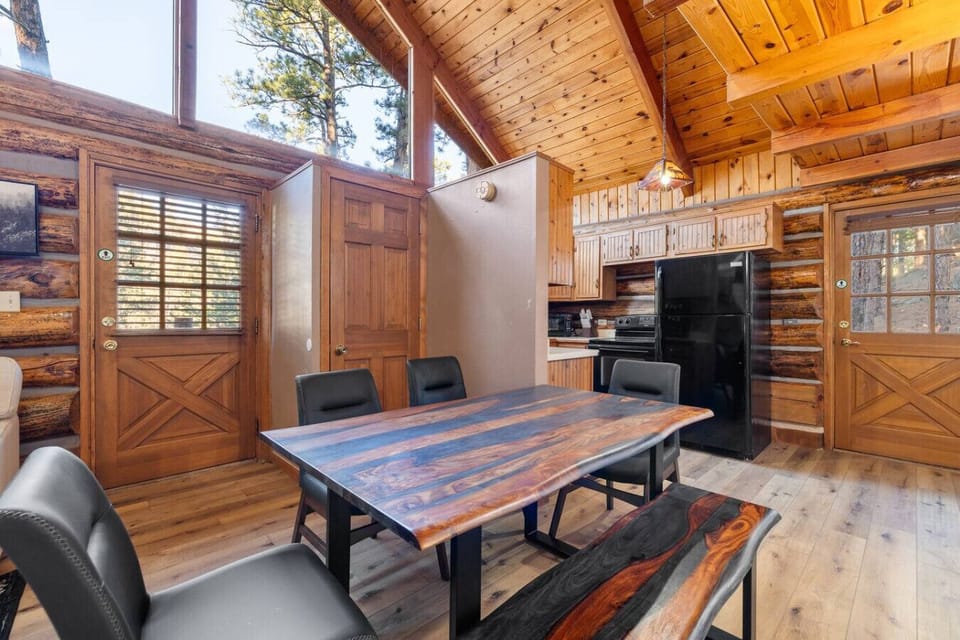 Open dining area with handcrafted wood table, located next to the fully equipped kitchen.