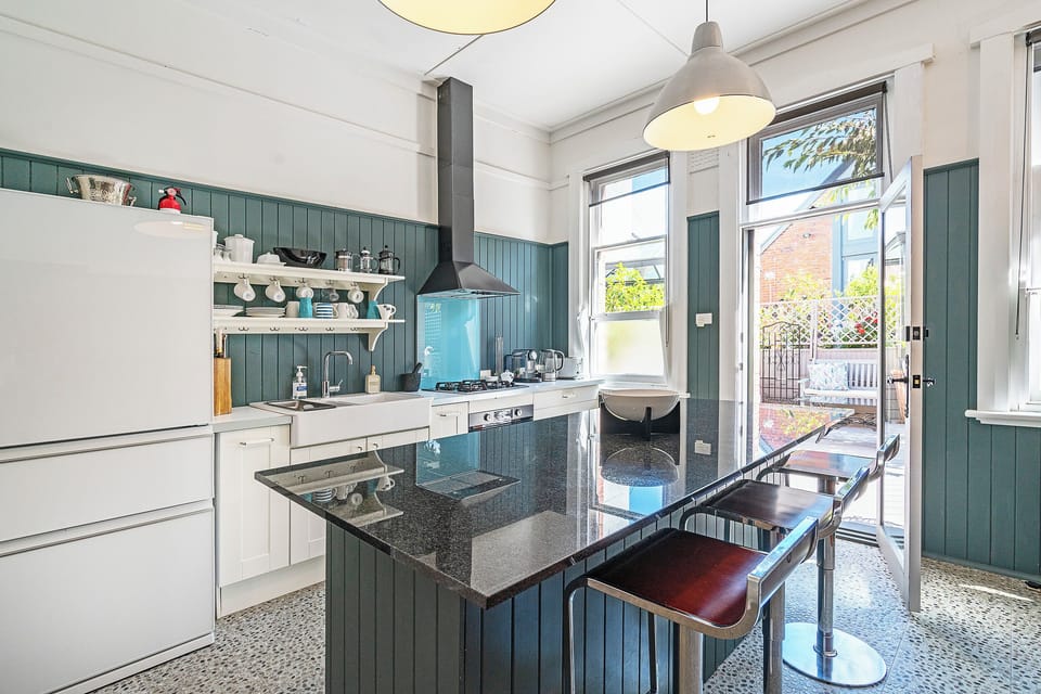 Cook with ease in the light-filled kitchen, gathering around the granite island as conversation flows between bench and window.