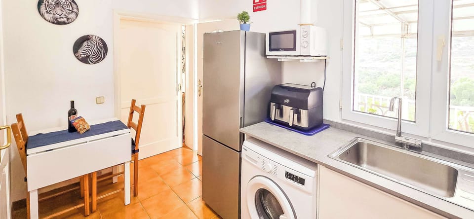 Fully equipped modern kitchen with everything you need for a comfortable stay. Facilities include a washing machine, air fryer, coffee machine, kettle, toaster, and all the crockery and cutlery required for easy self-catering