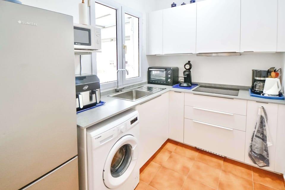 Fully equipped modern kitchen with everything you need for a comfortable stay. Facilities include a washing machine, air fryer, coffee machine, kettle, toaster, and all the crockery and cutlery required for easy self-catering