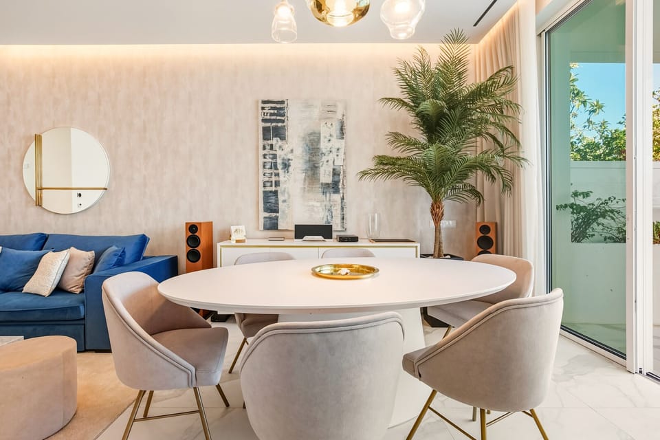 Elegant and modern living room with a dining table seating six, where guests can enjoy delicious meals.