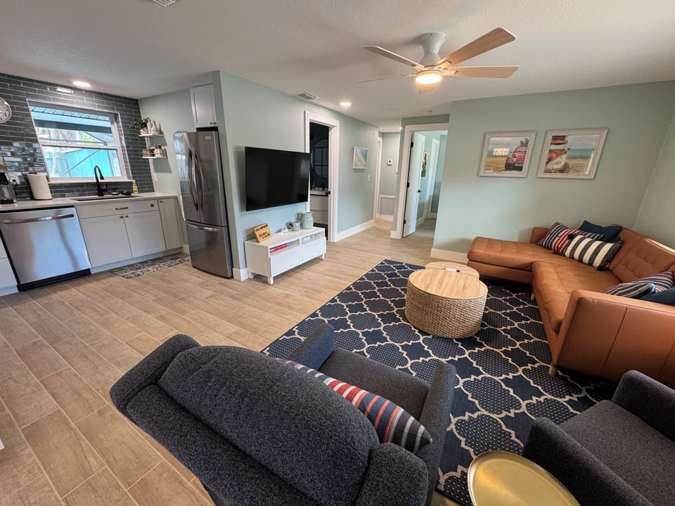 Living room with 55" smart TV and board games within console.