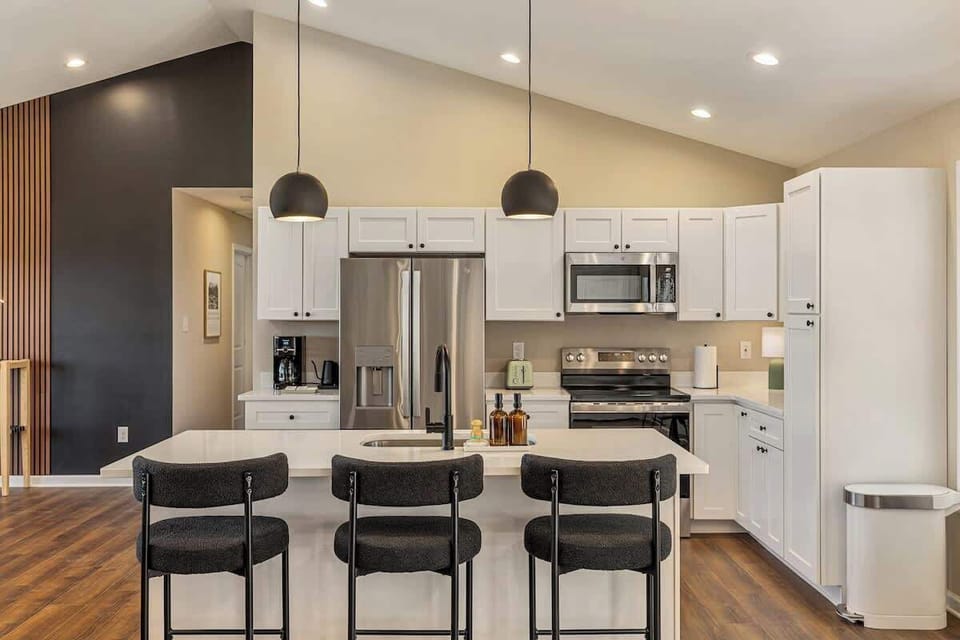 Bright chef’s kitchen with quartz island, stainless suite, coffee bar.