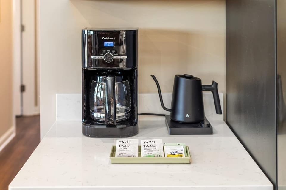 Coffee bar with Cuisinart brewer, gooseneck kettle, and Tazo teas.