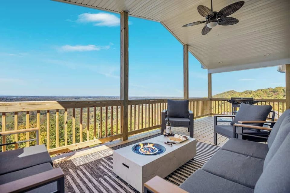 Covered deck with fire pit, lounge seating & sweeping mountain views