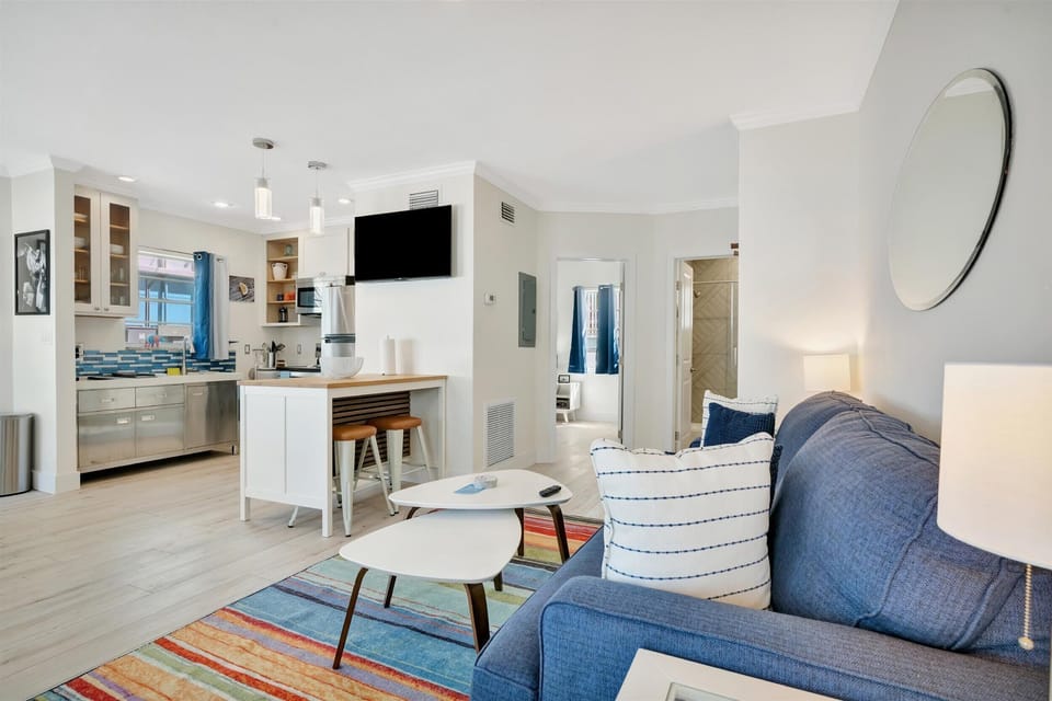 Open-concept lounge with beach-style furnishings and TV