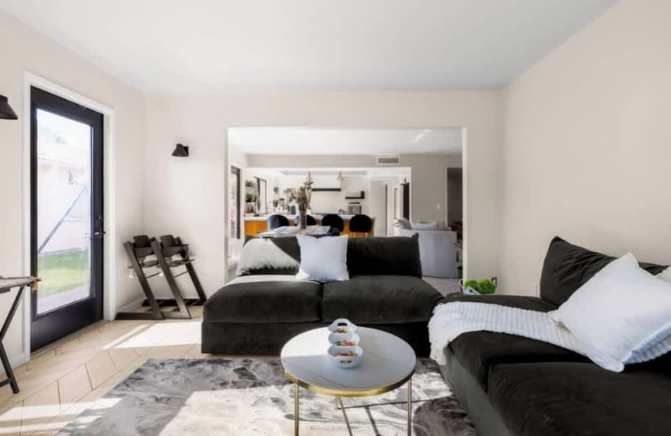 Relax in the spacious living room with cozy seating, smart TV, and warm fireplace vibes.
