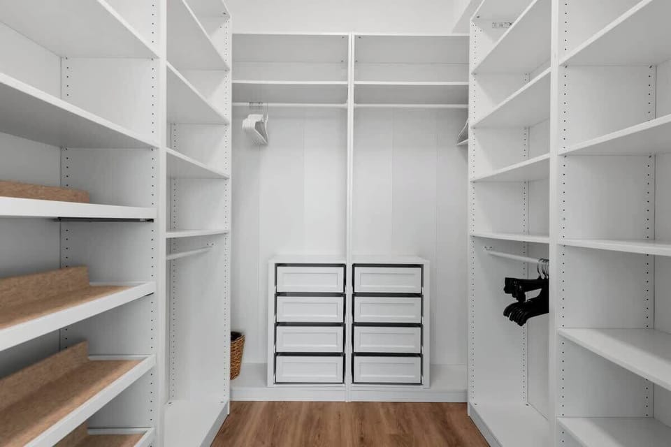 Spacious closet with hangers and storage space to keep your belongings neat and organized.