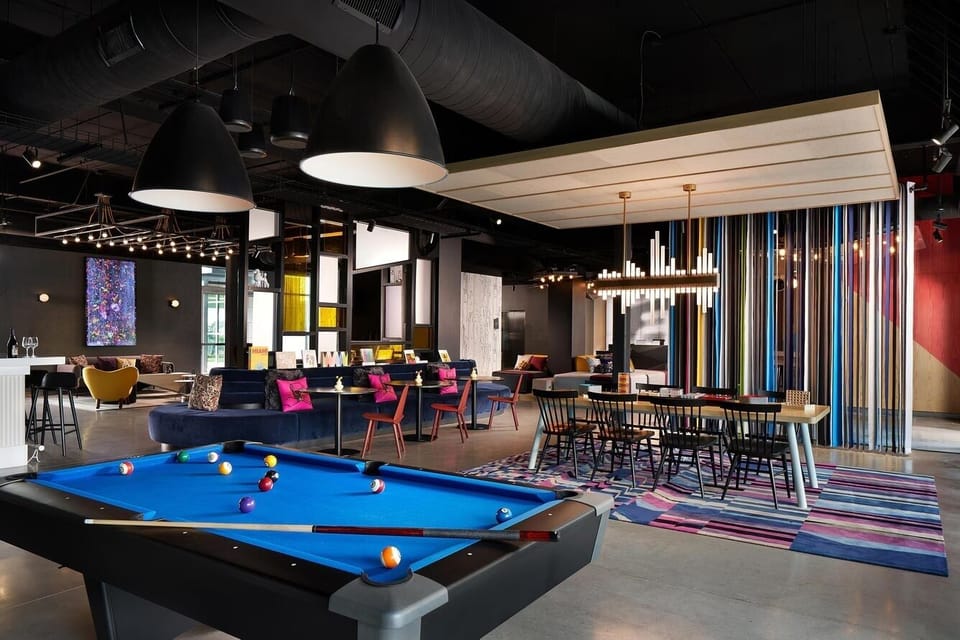 Challenge friends to a game of pool under designer lighting.
