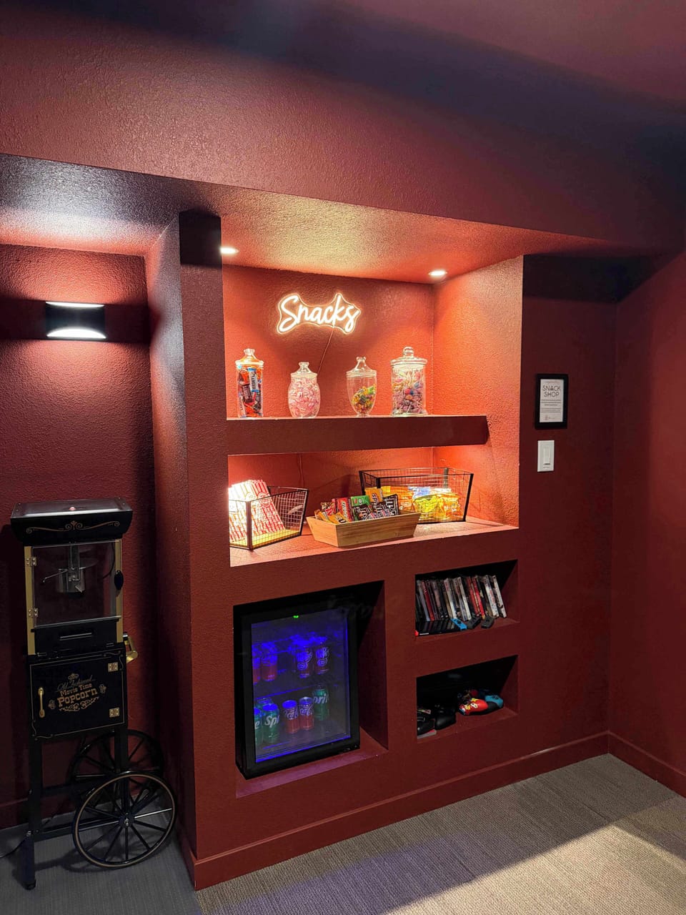 Full stocked vintage snack bar with popcorn maker, candy, chips and soda.