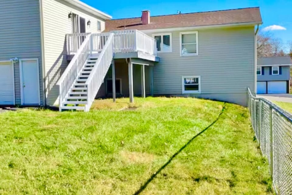 Fully fenced backyard retreat complete with an inviting deck, offering the perfect space for entertaining guests or unwinding outdoors.