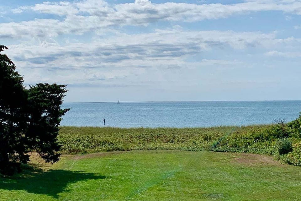 Vast yard leads down to the private beach on the Sound