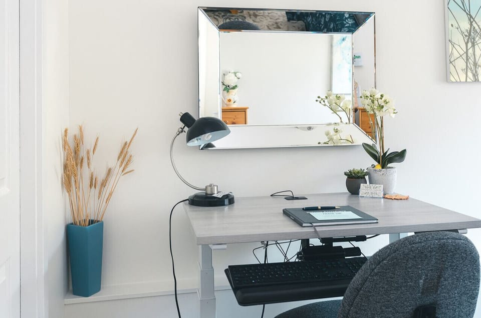 [Main Bedroom] Your ultimate workspace: Make the most of your stay with our dedicated office area, complete with an electric sit-stand desk, wired mouse, and keyboard for seamless productivity.