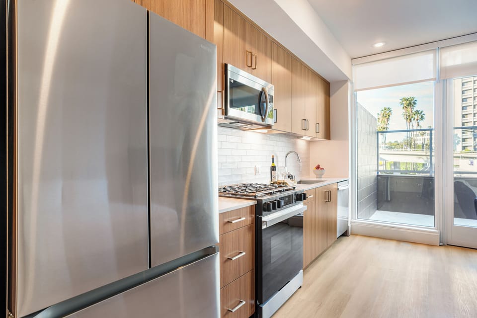 Cook in style with sleek quartz countertops, modern cabinetry, and stainless steel appliances.