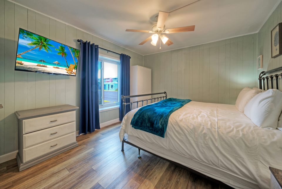 The bedroom features a king bed and a TV.