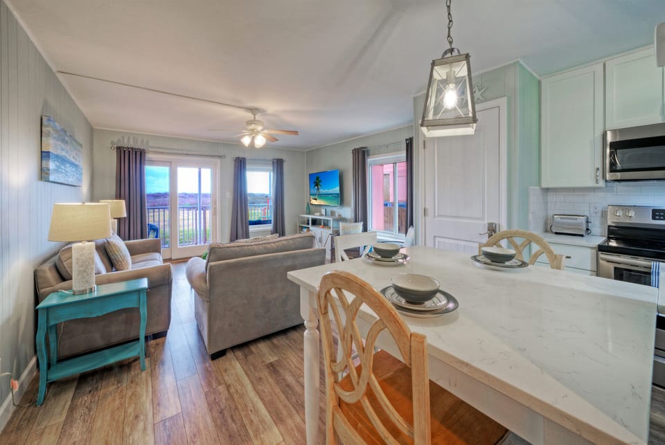 Cozy dining nook and fully equipped kitchen with coastal accents—perfect for easy breakfasts before a day at the beach.