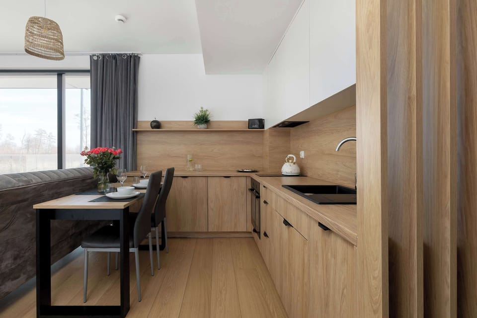 A kitchen corner with wooden cabinetry, built-in appliances, and subtle decor. The layout is practical and visually cohesive.