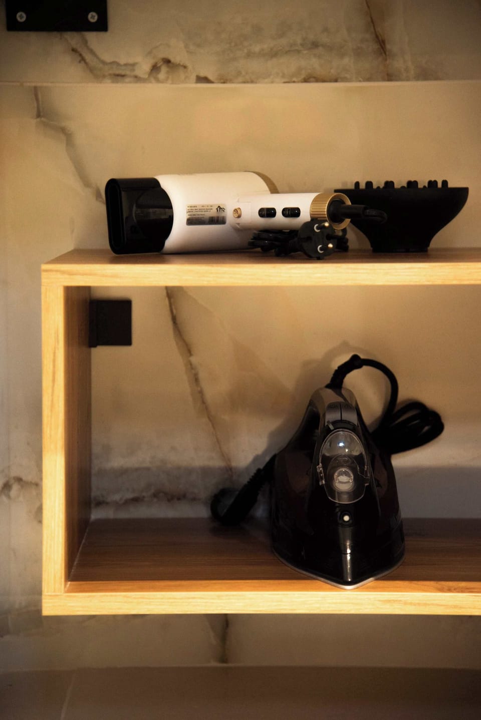Handy storage nook with iron and hairdryer for added convenience.