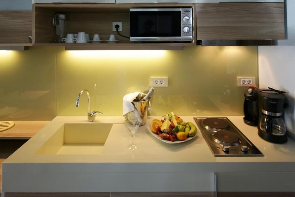 Deluxe Apartment, Balcony, Partial Sea View | Private kitchen | Fridge, highchair