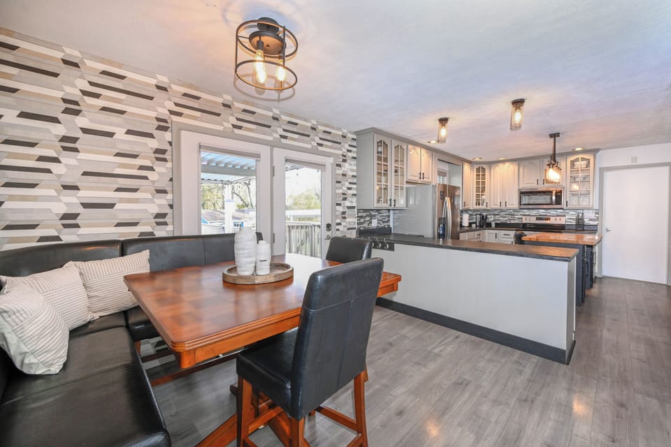 Adjacent to the kitchen, the dining area beckons with its sophisticated design and room for large gatherings. Bathed in natural light, it's an ideal setting for sharing meals and creating cherished memories with family and friends.