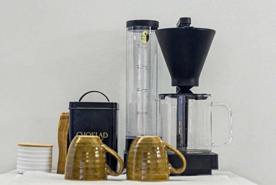 Coffee maker with mugs and essentials provided
