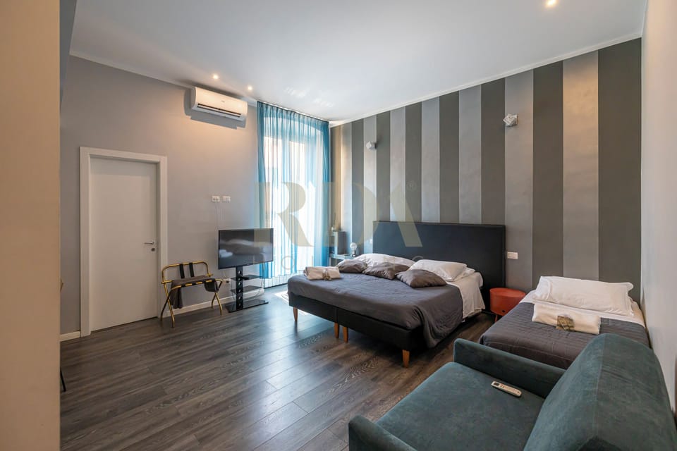 Deluxe Quadruple Room | In-room safe, individually decorated, individually furnished, desk