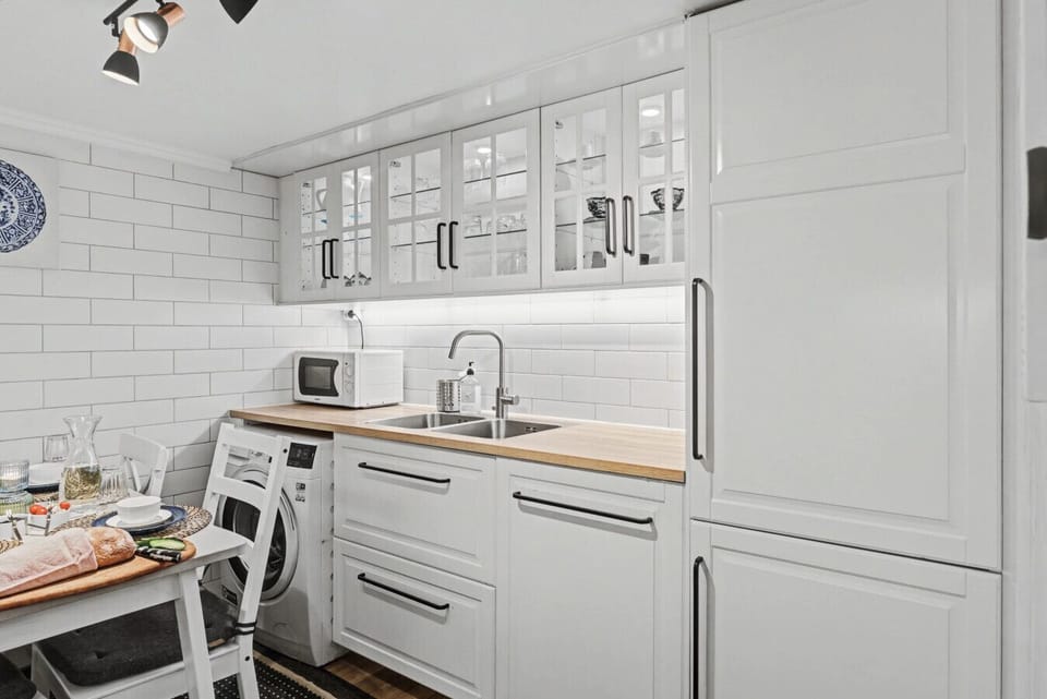Fully equipped family kitchen with integrated fridge, freezer, and dishwasher, ideal for extended visits.