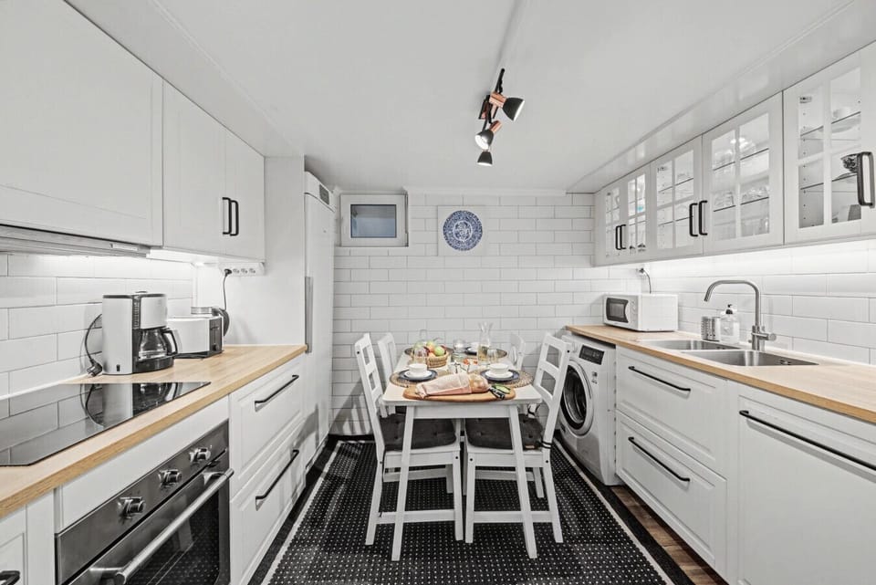Spacious family kitchen with oven, fridge freezer, dishwasher, and dining area for longer stays.