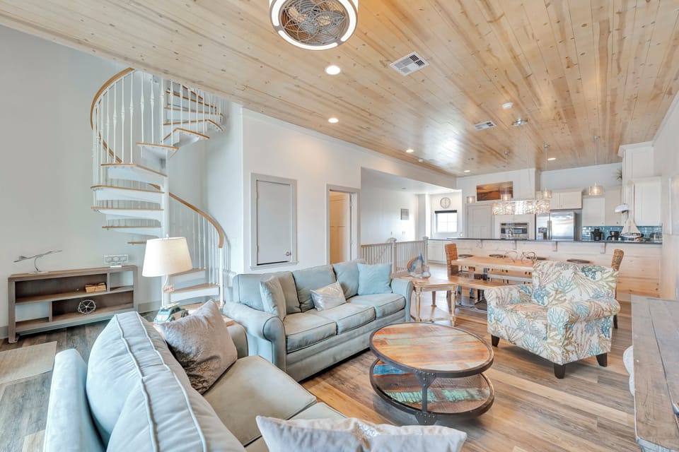 Unwind in your stylish coastal living space with soaring wood ceilings, comfortable seating, and an open layout perfect for gathering.