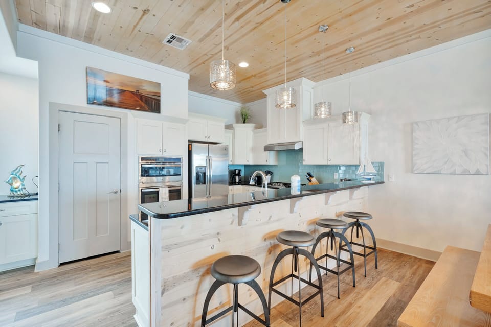 Cook gourmet meals in your dream kitchen with marble island, stainless appliances, and stunning pendant lighting overhead.