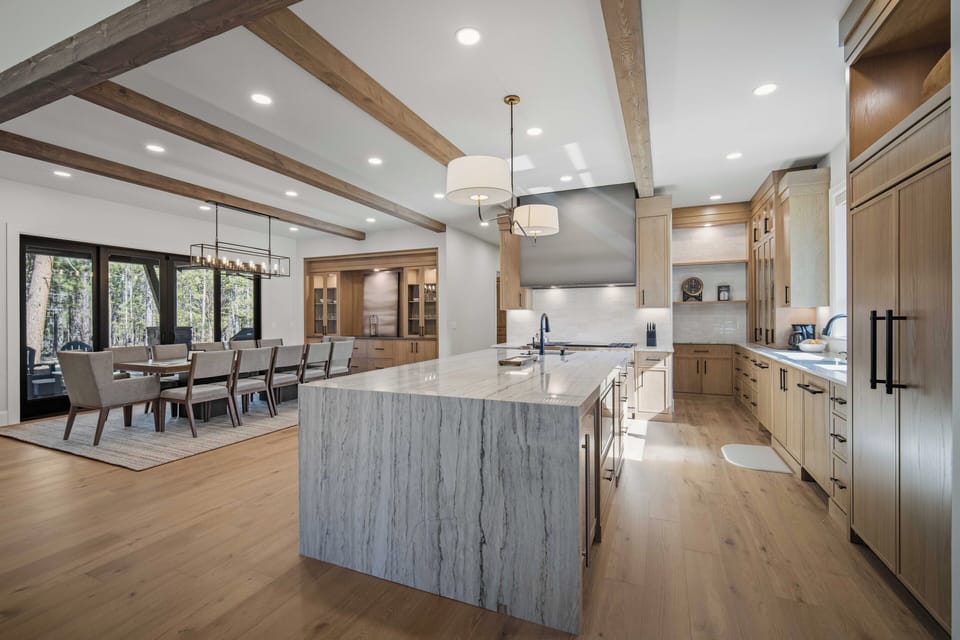 You'll love preparing meals in this stunning gourmet kitchen with marble island, custom cabinetry, and open flow to your elegant dining space.