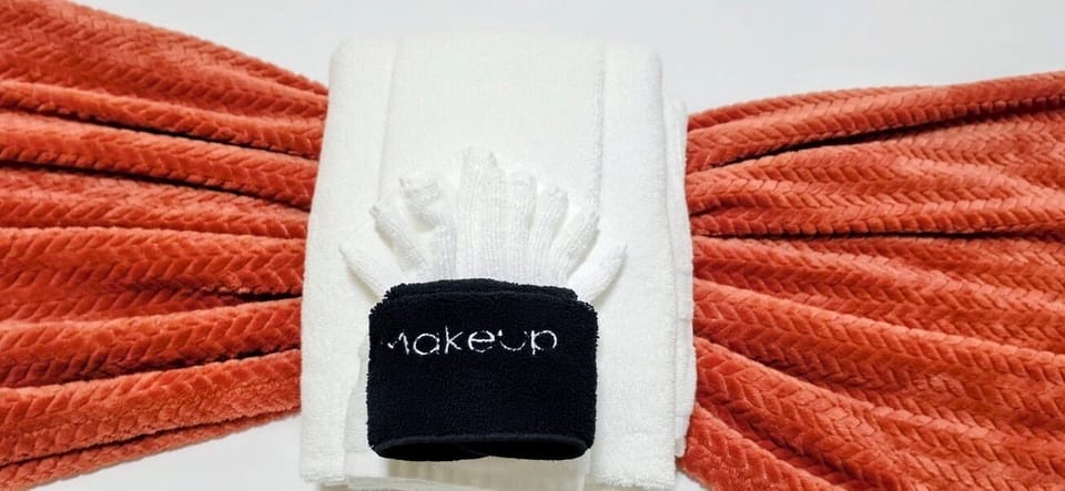 Thoughtful towel setup with makeup cloth and stylish coral accents